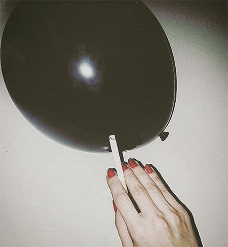 Cigarette About to Pop Black Balloon