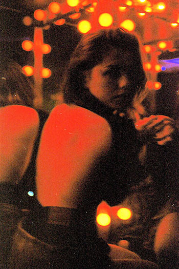 Girl in Bar with Open Back Top Looking Over Shoulder