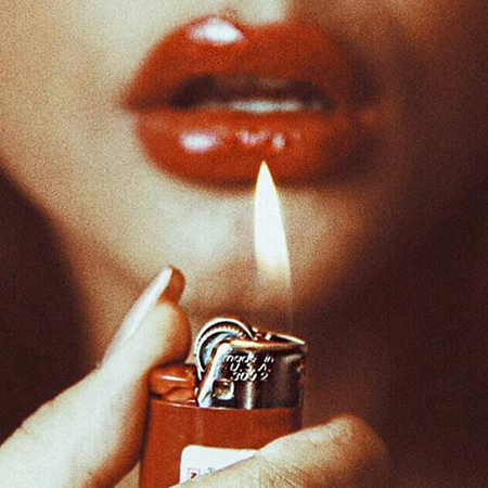 Girl with Cigarette Lighter in Front of Her Face with Red Lipstick
