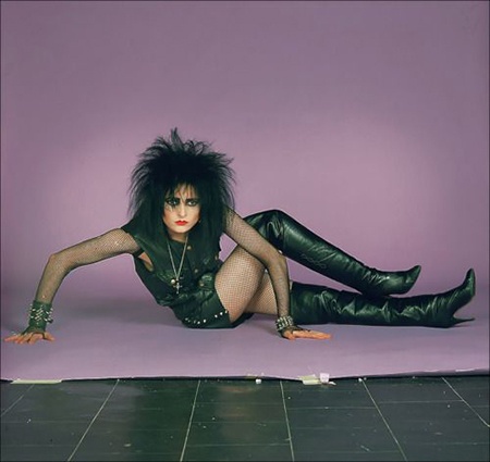 Siouxsie Sioux of The Banshees Photographed Against Pink Background in Black Leather
